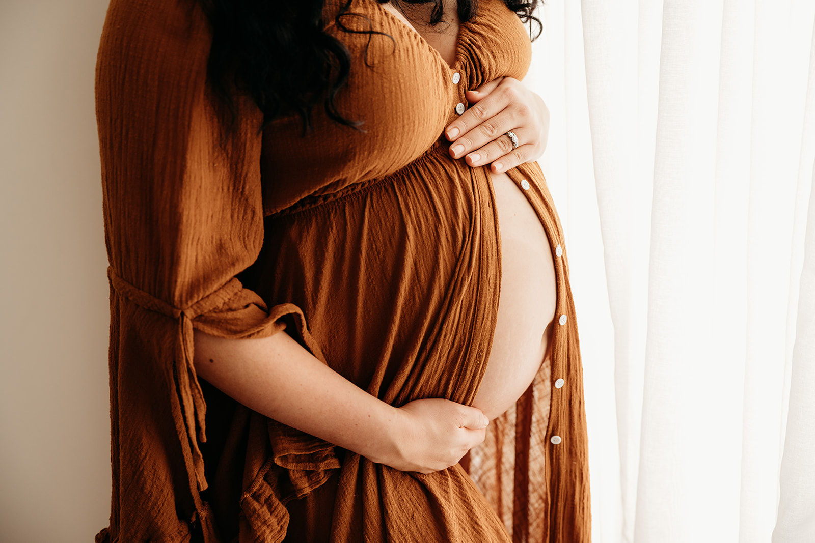 Candice wearing a beautiful maternity gown from michelle kellys photography studio client wardrobe in papakura during her auckland maternity photoshoot