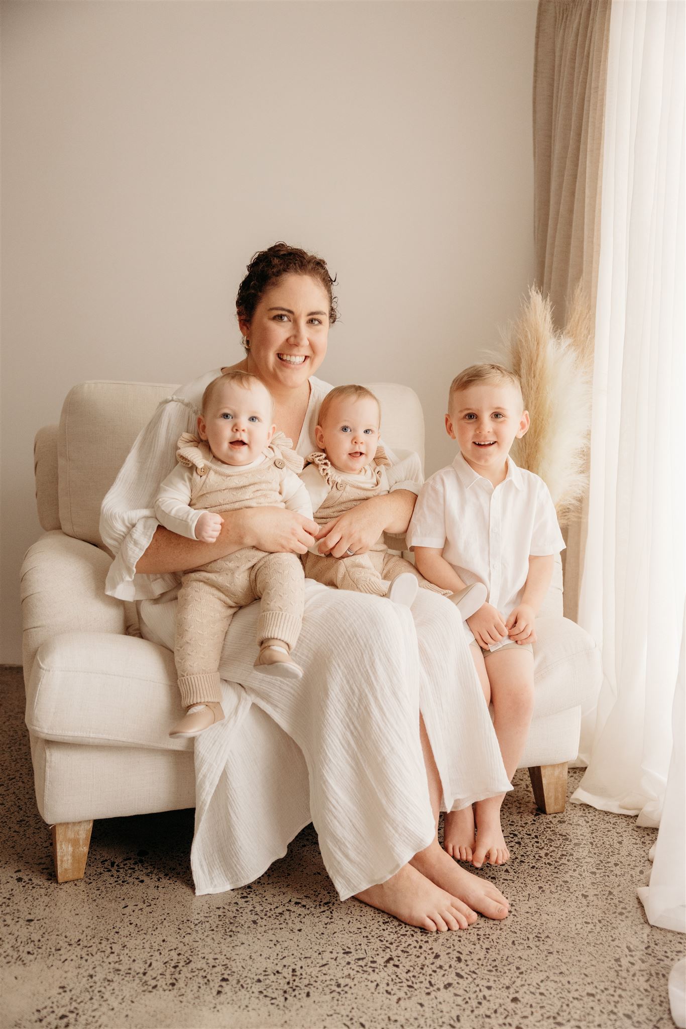 Hannah and her beautiful children wearing matching toned outfits for their studio photoshoot in auckland with family photographer michelle kelly photography